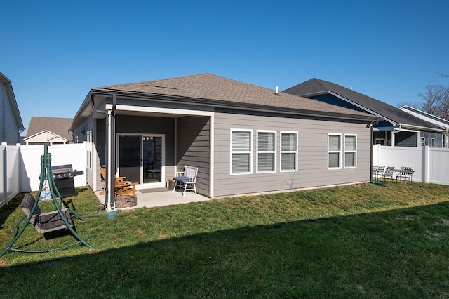 rear view of house with a lawn and a patio