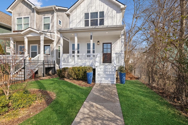 view of front of property featuring covered porch and a front yard