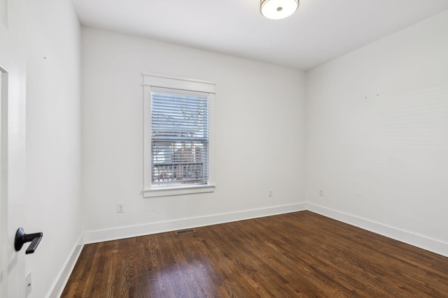 spare room with dark hardwood / wood-style floors