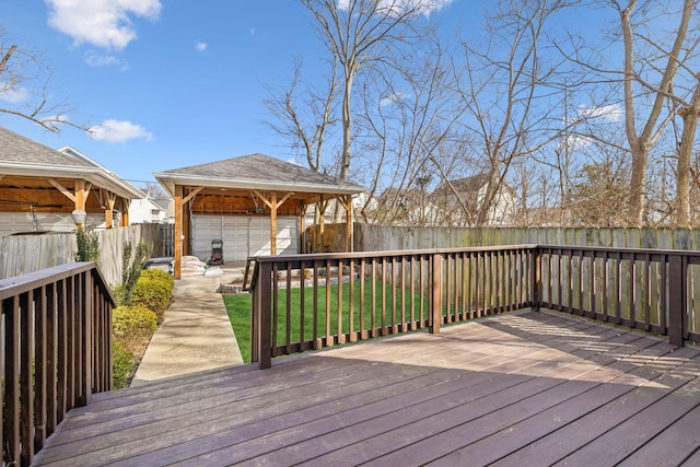 wooden terrace featuring a gazebo and a yard