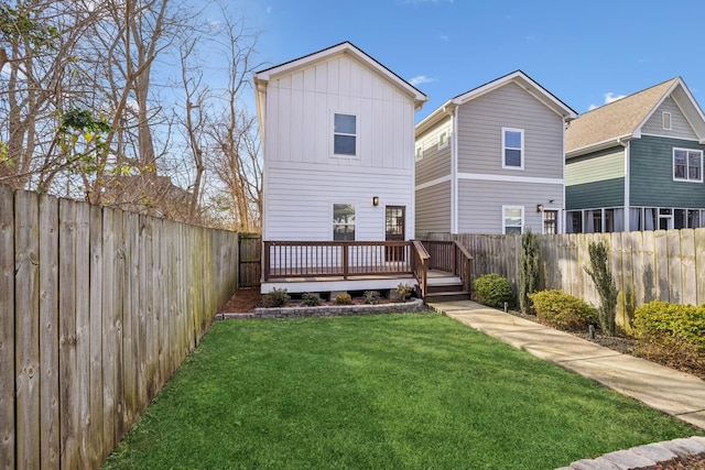 back of property featuring a yard and a deck