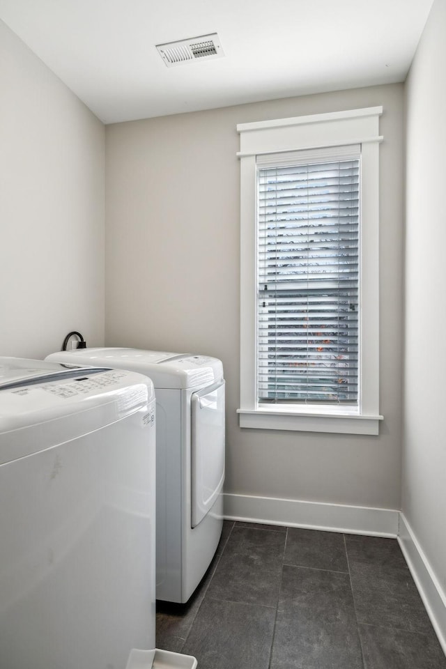 clothes washing area featuring washer and dryer