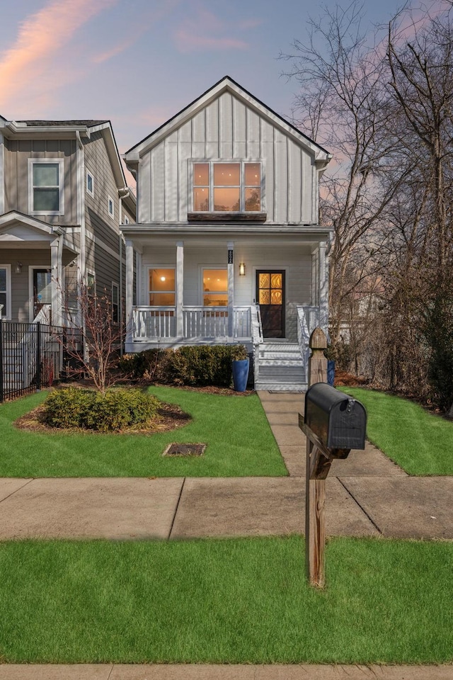 view of front of property featuring a yard and covered porch