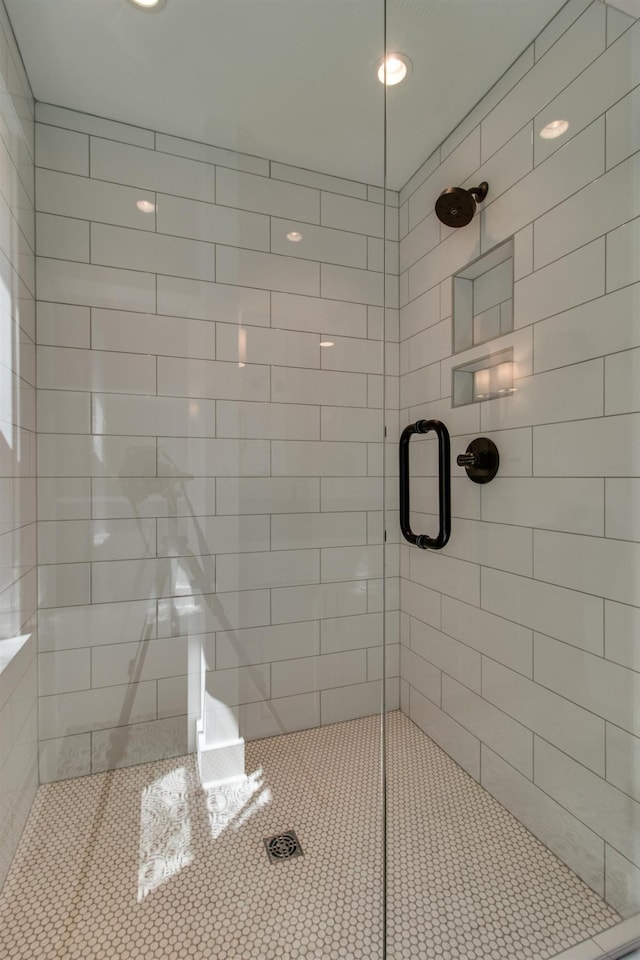 bathroom with a shower with door