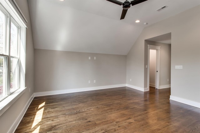 bonus room featuring ceiling fan, dark hardwood / wood-style flooring, vaulted ceiling, and a wealth of natural light