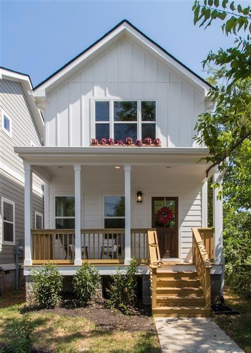 rear view of house featuring a porch