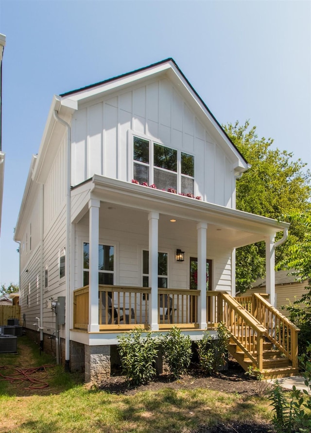 view of front facade with a porch and central AC