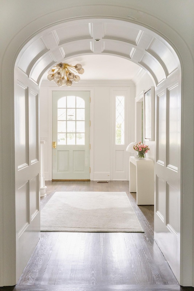 entrance foyer with light hardwood / wood-style flooring, lofted ceiling, and a chandelier