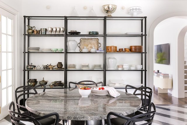 tiled dining space featuring plenty of natural light