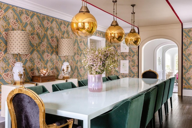 dining room with dark wood-type flooring and crown molding