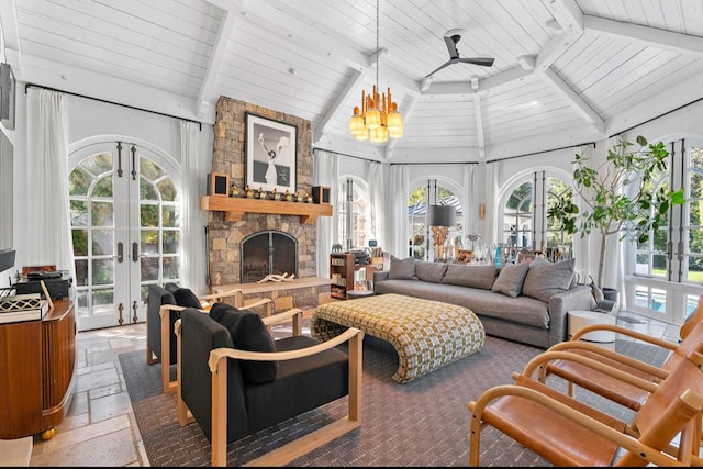 sunroom featuring ceiling fan with notable chandelier, a wealth of natural light, french doors, a fireplace, and lofted ceiling with beams