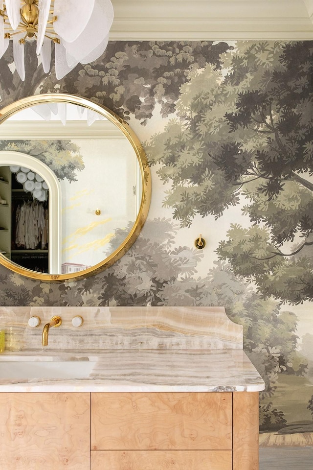 interior details featuring sink and crown molding