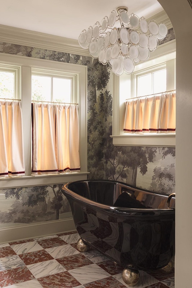 bathroom featuring a bath and ornamental molding