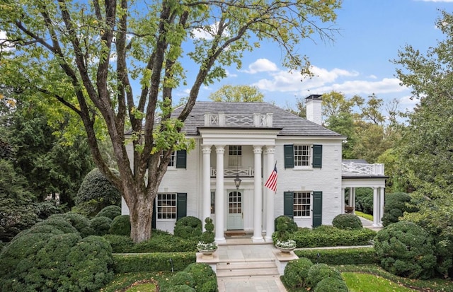 neoclassical home with a balcony