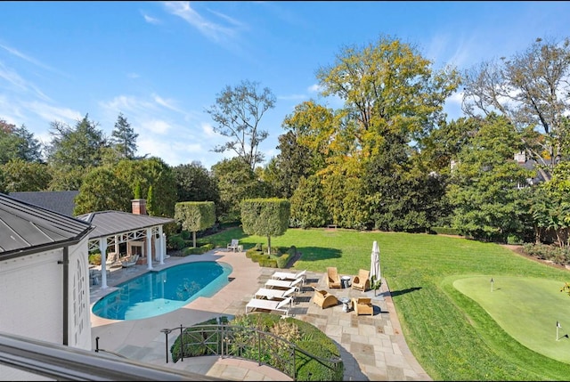 view of swimming pool featuring a yard and a patio