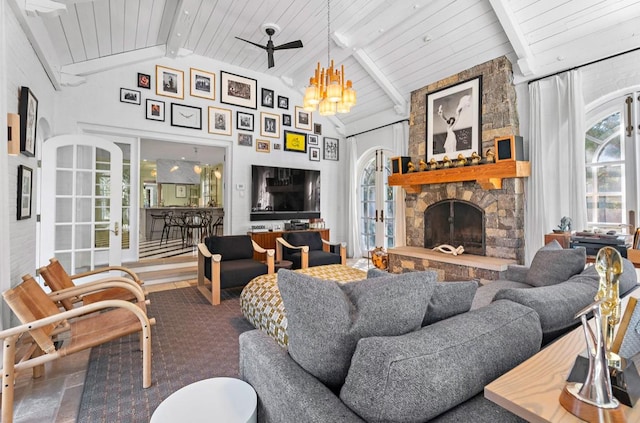 living room featuring ceiling fan, a fireplace, and lofted ceiling with beams