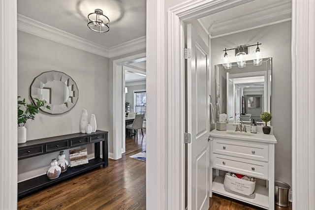 interior space with dark wood-type flooring, sink, and crown molding