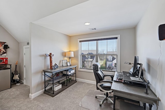 carpeted home office featuring lofted ceiling