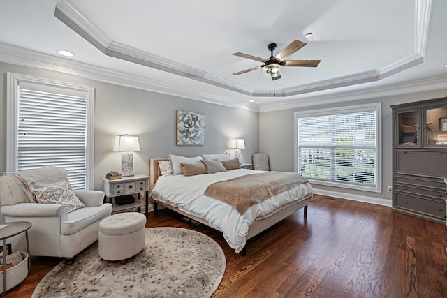 bedroom featuring ceiling fan, ornamental molding, and a raised ceiling