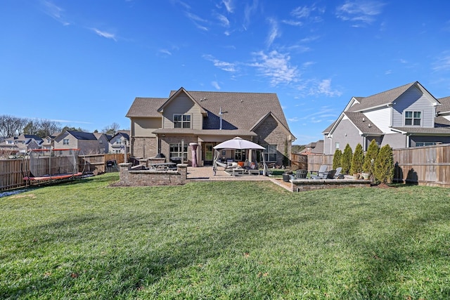 back of property with a patio area and a lawn