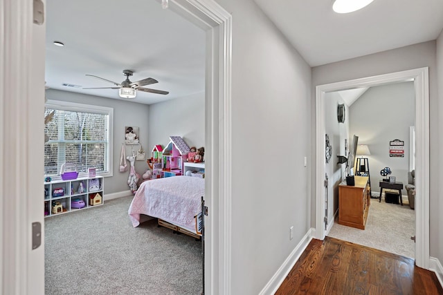 bedroom featuring ceiling fan and dark carpet