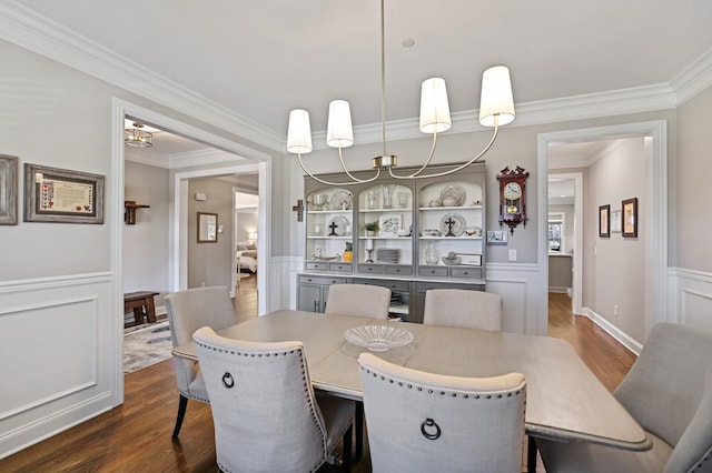 dining area featuring ornamental molding and dark hardwood / wood-style floors