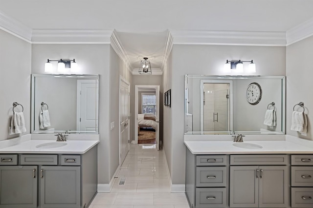 bathroom with a chandelier, ornamental molding, and vanity