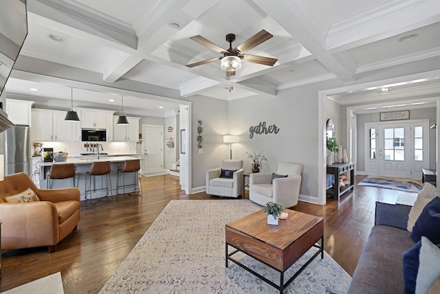 living room featuring ceiling fan, beamed ceiling, and coffered ceiling