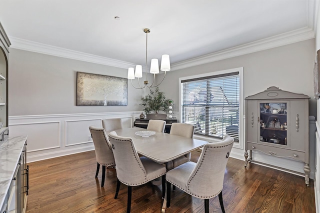 dining space with dark hardwood / wood-style floors, an inviting chandelier, and ornamental molding