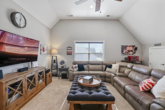 carpeted living room with ceiling fan and vaulted ceiling