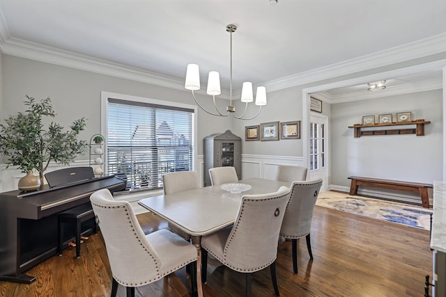 dining space with dark hardwood / wood-style flooring, crown molding, and a notable chandelier