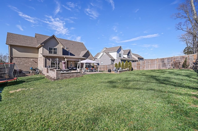 view of yard featuring a gazebo, a trampoline, and a patio area