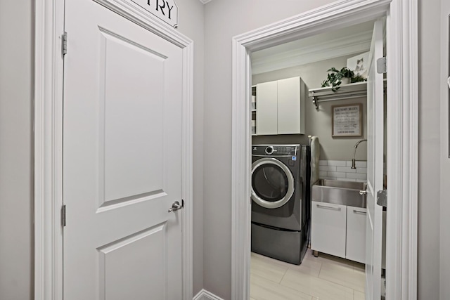 clothes washing area with cabinets, light tile patterned floors, sink, and washer / clothes dryer