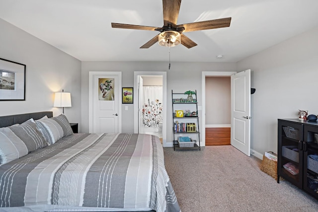 carpeted bedroom featuring ceiling fan and ensuite bath