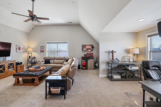 living room with ceiling fan, light colored carpet, and vaulted ceiling