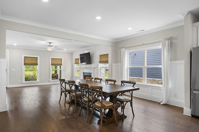 dining space with dark wood-type flooring, ceiling fan, and ornamental molding