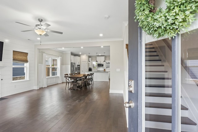 interior space with ceiling fan, dark hardwood / wood-style flooring, and crown molding