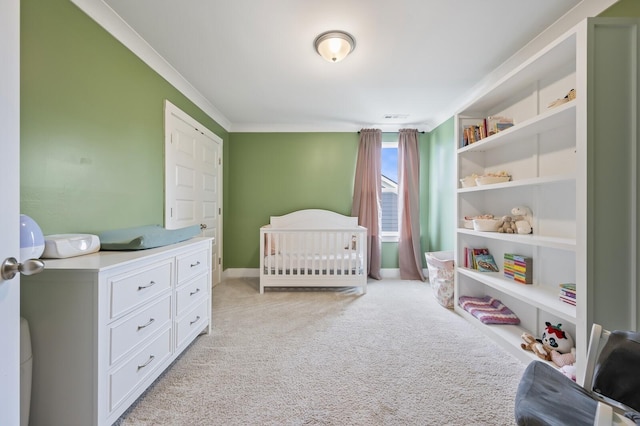 carpeted bedroom featuring a crib and ornamental molding