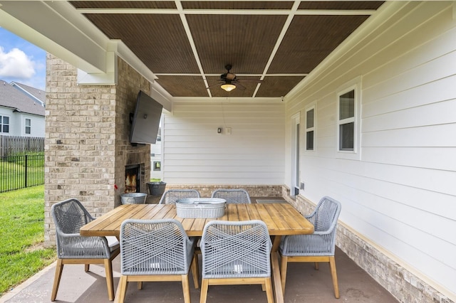 view of patio / terrace with ceiling fan and an outdoor stone fireplace