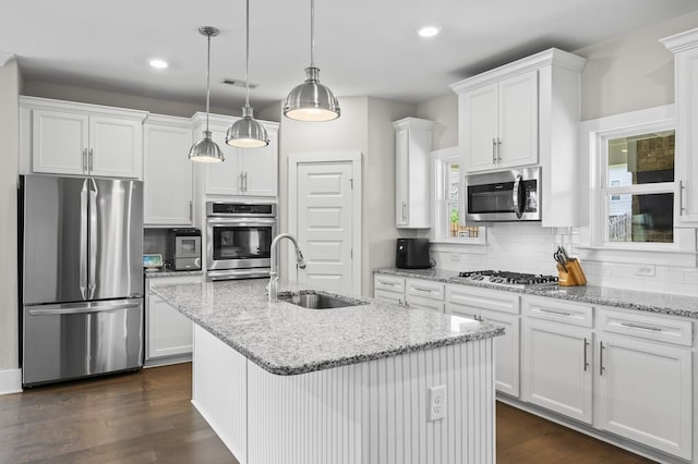 kitchen featuring pendant lighting, sink, white cabinetry, and stainless steel appliances