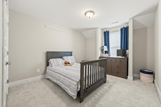 carpeted bedroom with lofted ceiling