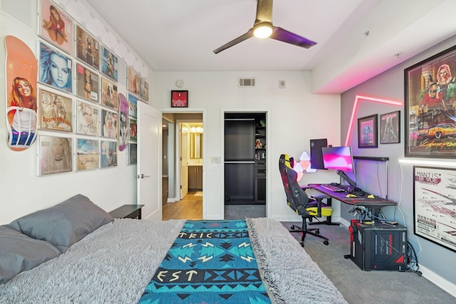 carpeted bedroom featuring ceiling fan and a closet