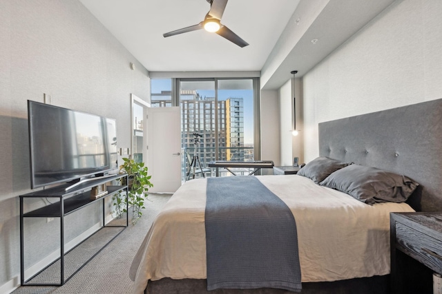 bedroom featuring ceiling fan, light colored carpet, and floor to ceiling windows