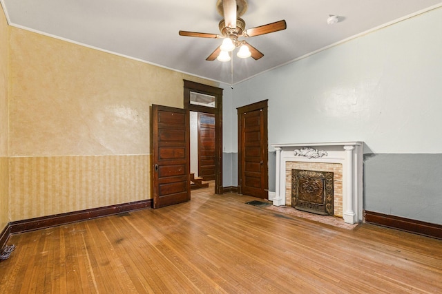 unfurnished living room featuring ceiling fan, light hardwood / wood-style flooring, and crown molding