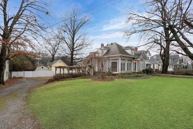 view of side of property featuring a yard