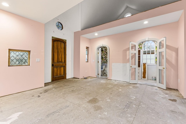 entrance foyer featuring high vaulted ceiling