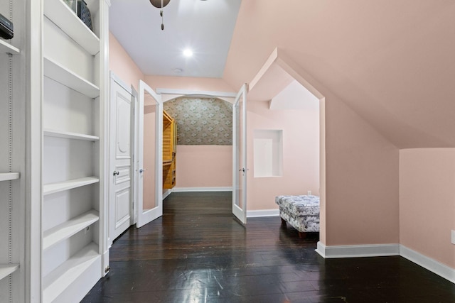 hall featuring built in shelves and dark hardwood / wood-style flooring