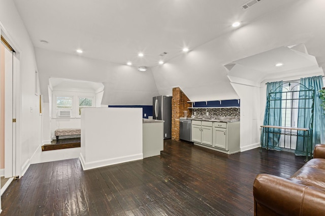 living room with vaulted ceiling, dark wood-type flooring, sink, and cooling unit