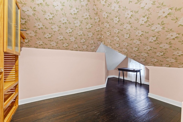 bonus room with dark hardwood / wood-style floors