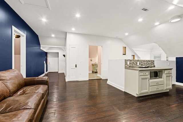 living room with vaulted ceiling and dark hardwood / wood-style flooring